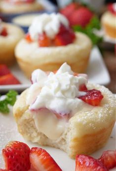 strawberry shortcakes with whipped cream and fresh strawberries on the side are ready to be eaten