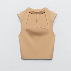 Sleeveless High Collar Top. Front Opening. Back Zip Closure. Light Camel Color. 56% Nylon 44% Viscosa All Items Are Cross Posted Elegant Sleeveless Fitted Crop Top, Chic Sleeveless Crop Top For Fall, Beige Stretch Vest Crop Top, Fitted Sleeveless Chic Crop Top, Beige Fitted Sleeveless Crop Top, Fitted Sleeveless Beige Crop Top, Chic Fitted Sleeveless Crop Top, Beige Stretch Vest Top, Chic Fitted Sleeveless Knit Top