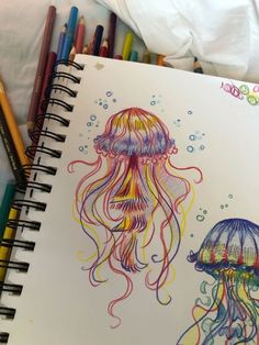 a drawing of two jellyfishs with colored pencils next to eachother