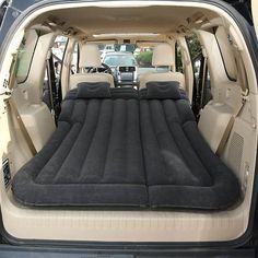 an inflatable mattress is placed inside the back of a car's trunk