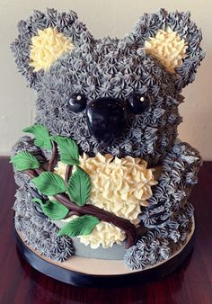 a cake made to look like a koala bear with leaves on it's chest