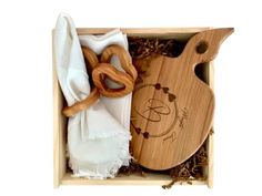 a wooden cutting board and napkins in a box