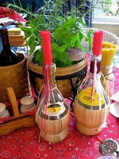 several bottles of wine are sitting on a table with other items around it and plants in the background