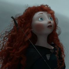 a doll with long red hair holding an arrow and looking up at the sky in front of her