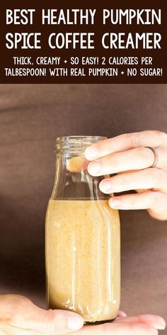 a person holding a jar with coffee creamer in it and text overlay that reads best healthy pumpkin spice coffee creamer