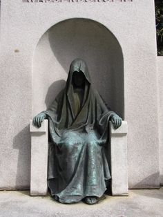 a statue of a person sitting on a bench