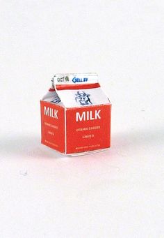 a carton of milk sitting on top of a white table