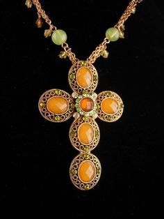 This gorgeous peridot color Cross necklace looks like it has never been worn. The setting is really pretty with a green rhinestone accents around the faceted amber color stones. Even prettier in person, this Gothic cross has loads of rich sparkle and looks very Edwardian or goth. You are sure to get compliments with this. 11-6-18 Jeweled Cross Jewelry Gift, Jeweled Cross Jewelry For Gifts, Cross-shaped Jeweled Jewelry For Gifts, Cross-shaped Jeweled Jewelry Gift, Green Spiritual Cross Pendant Jewelry, Green Rhinestone Necklace For Gift, Green Necklaces With Rhinestones As Gift, Handmade Green Cross Jewelry, Gothic Cross Necklace