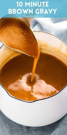 a ladle pouring gravy into a white bowl filled with brown gravy