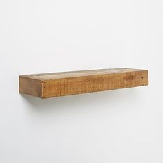 a wooden shelf mounted to the side of a wall with no one around it or someone else