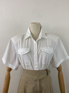 This is a basic blouse for your wardrobe. No shoulder pads in perfect condition. Amazing fabrics. 36" to 40" chest  18" shoulder to shoulder Classic Fitted Plain Blouse, Classic Collared Blouse, Classic Collared Plain Blouse, Classic Plain Summer Blouse, Classic Plain Blouse For Summer, Vintage Solid Color Tops For Workwear, Vintage Solid Color Tops For Work, Solid Vintage Tops For Workwear, Basic Blouse