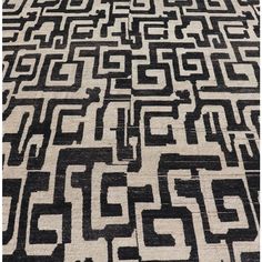 an area rug with black and white designs on it's edges, in the shape of mazes