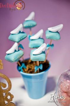 there is a potted plant with blue and white cookies in it on the table