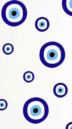 blue and black circles on white paper with dots in the middle, as well as an eye