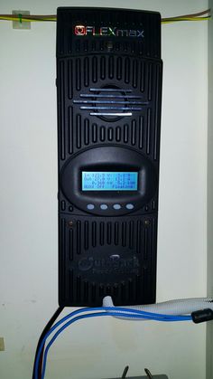 an image of a radio that is connected to the wall with wires and plugged in