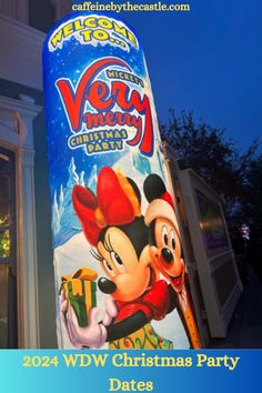 a very merry christmas party sign in front of a building with mickey mouse on it