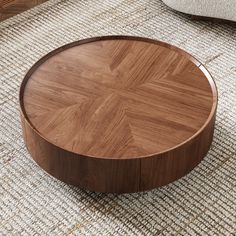 a close up of a wooden table on a carpeted floor with a chair in the background