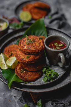 some food is sitting on a plate and ready to be eaten with dipping sauces