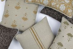 several decorative pillows are arranged on a white surface