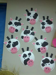 paper plates with farm animals on them are arranged in the shape of cow's heads