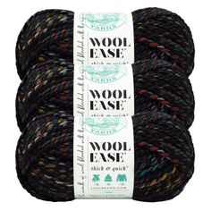 two skeins of wool ease yarn in black and brown