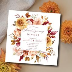 a floral thanksgiving dinner party with flowers on the table and an orange flower arrangement next to it