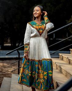 This Shimena Habesha dress is a true masterpiece that embodies timeless elegance and sophistication. The dress is made with high-quality Menen fabric, which adds a touch of luxury and refinement to the overall design. The dress features a wide Tilf design that adds a traditional charm to the modern silhouette. The dress is designed to fit comfortably and flatteringly, with a fitted bodice and a full skirt that flows beautifully as you move. The dress is complemented by carefully selected accesso Eritrean Dress, Habesha Dress, Habesha Kemis, Wedding Dress Chiffon, Design 2023, Dresses Chiffon, Luxury Dresses, Wedding Dresses Simple, Dress Design