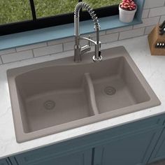 an image of a kitchen sink with faucet spouting from the side