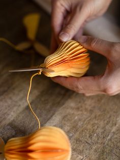 a person is working on something that looks like an object with orange and yellow colors