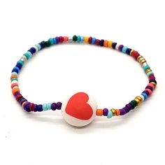 Boho Stackable Stretch Bracelet. Seed Glass Multi-Color Beads. Polymer Clay Heart Lentil Color Red And White. 1 Bracelet. Measures 6 In. Handmade. Fun, Colorful, Hippie Style, Peace, Love, Heart. Adjustable Heart Beads Bracelet With Round Beads, Bohemian Heart Bracelet With Colorful Round Beads, Multicolor Beaded Bracelets With Heart Charm For Valentine's Day, Adjustable Heart Bracelet With Tiny Beads, Casual Multicolor Beaded Heart Bracelet, Multicolor Beaded Bracelets With Heart Beads For Valentine's Day, Valentine's Day Multicolor Beaded Bracelets With Heart Beads, Adjustable Heart Bracelet With Colorful Beads, Heart-shaped Multicolor Beaded Bracelets For Festivals