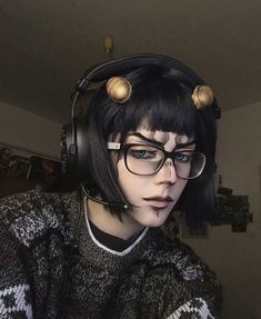 a woman wearing headphones and glasses with hair in the shape of birds on her head