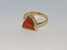 Natural red coral triangle (moonga) gemstone ring in panchdhatu metal for vedic astrology mars planet birthstone  Gemstone name- Natural coral Gemstone color- Red Gemstone shape- Triangle Gemstone quality- AA quality Ring metal- Panchdhatu Gemstone authenticity certificate will be provided. *Handmade product with natural gemstone so final product may vary slightly from product picture. Contact us for any query. Modern Red Cabochon Jewelry, Trillion Cut Rings With Polished Finish For Gift, Trillion Cut Polished Ring, Gift, Trillion Cut Ring With Polished Finish As Gift, Red Moonstone Gemstone Ring As Gift, Red Moonstone Gemstone Ring For A Gift, Untreated Red Rings For Gift, Untreated Red Rings As A Gift, Red Untreated Rings As A Gift