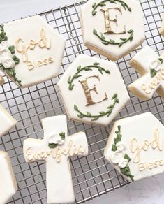 decorated cookies on a cooling rack with the letters e, f, g and h