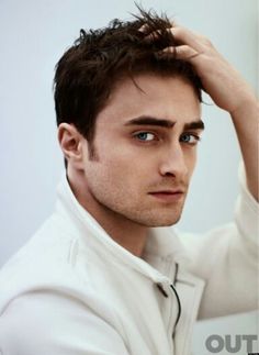 a close up of a person wearing a white shirt and tie with his hand on his head