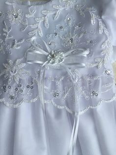 Details Amazingly elegant christening gown of embroidered tulle has beaded accents throughout. Ribbon bow at bodice and petite bows on each cap sleeve. Bottom of skirt has a scalloped trim. Includes a matching bonnet to complete the look. Sizes Available: X-Small (0-3 Months), Small (3-6 Months), Medium (6-12 Months), and Large (12-18 Months) Made in the USA by Lito Childrens Wear. Dry Clean only. Fitted Tulle Baptism Dress With Bow, First Communion Dress With Lace Bodice In Organza, Fitted Organza First Communion Dress With Lace Bodice, Elegant Tulle First Communion Dress, Elegant First Communion Dress With Lace Bodice In Organza, Elegant First Communion Dress With Lace Bodice And Organza, Embroidered Tulle Dress For Ceremonies, Elegant Tulle Baptism Dress For Ceremony, Elegant First Communion Dress With Fitted Bodice