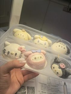 a plastic container filled with hello kitty cupcakes