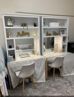 two white desks sitting next to each other on top of a carpeted floor