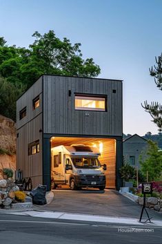 a truck is parked in front of a house with a garage on the top floor