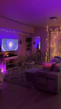 a living room filled with furniture and purple lights on the wall above it is a flat screen tv