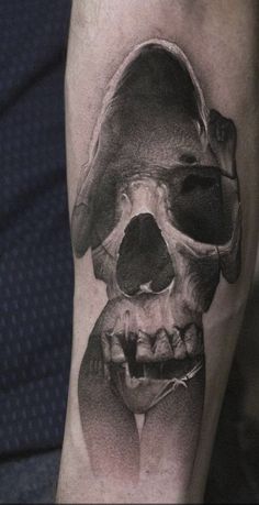 a black and white photo of a skull on the leg