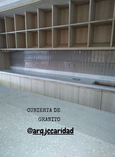 an empty kitchen with wooden cabinets and granite counter tops