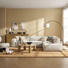 a living room filled with lots of furniture and decor on top of a hard wood floor