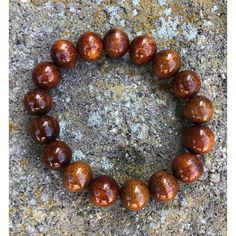 Koa Wood Bead Bracelet 12mm - Makana Hut Casual Wooden Beaded Jewelry, Natural Wood Round Beads Bracelet Gift, Gift Natural Wood Round Bead Bracelets, Gift Natural Wood Round Beads Bracelet, Brown Stretch Bracelet For Meditation, Brown Stretch Bracelet With 8mm Round Beads, Casual Brown Stretch Bracelet For Healing, Wood Bead Bracelet, Koa Wood