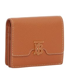 Burberry presents this TB Monogram bifold wallet in grained leather for a textured feel. The supreme utility of this style is matched only by the polished details, such as the application of hand-painted edges and gold-tone finishings on the signature hardware. Luxury Leather Wallet With Grained Texture, Luxury Wallets With Grained Texture For Formal Occasions, Formal Bifold Wallet With Embossed Logo, Leather Bifold Wallet With Embossed Logo, Gold Bifold Wallet For Business, Classic Tan Business Wallets, Tan Bifold Wallet With Card Slots, Classic Gold Bifold Wallet, Designer Tan Bifold Wallet