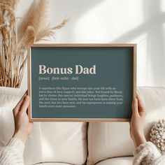 a person holding up a sign that says,'bonus dad '