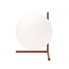 a white ball sitting on top of a metal stand with a red rod around it