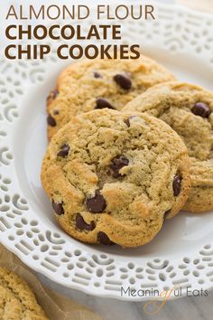 three chocolate chip cookies on a white plate