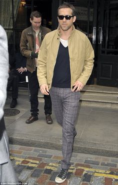 a man walking down the street with sunglasses on