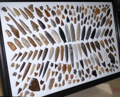 some kind of art with many different types of stones in it's shadow box