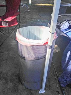 two chairs and a trash can are sitting on the ground